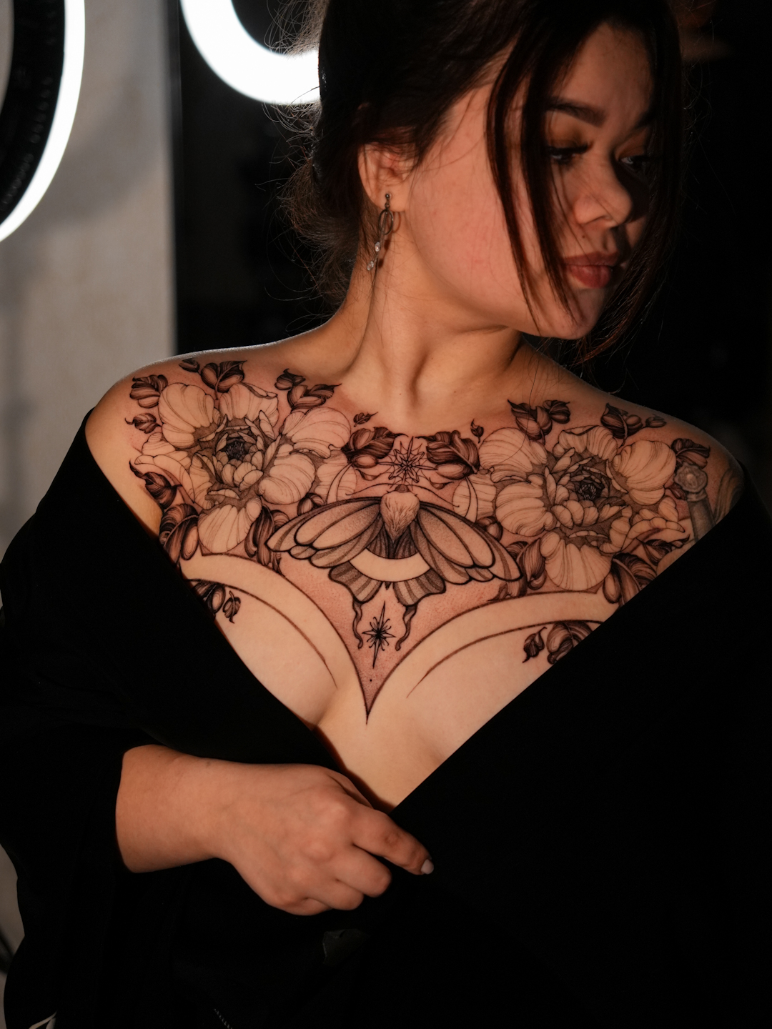 Fine-line floral chest tattoo