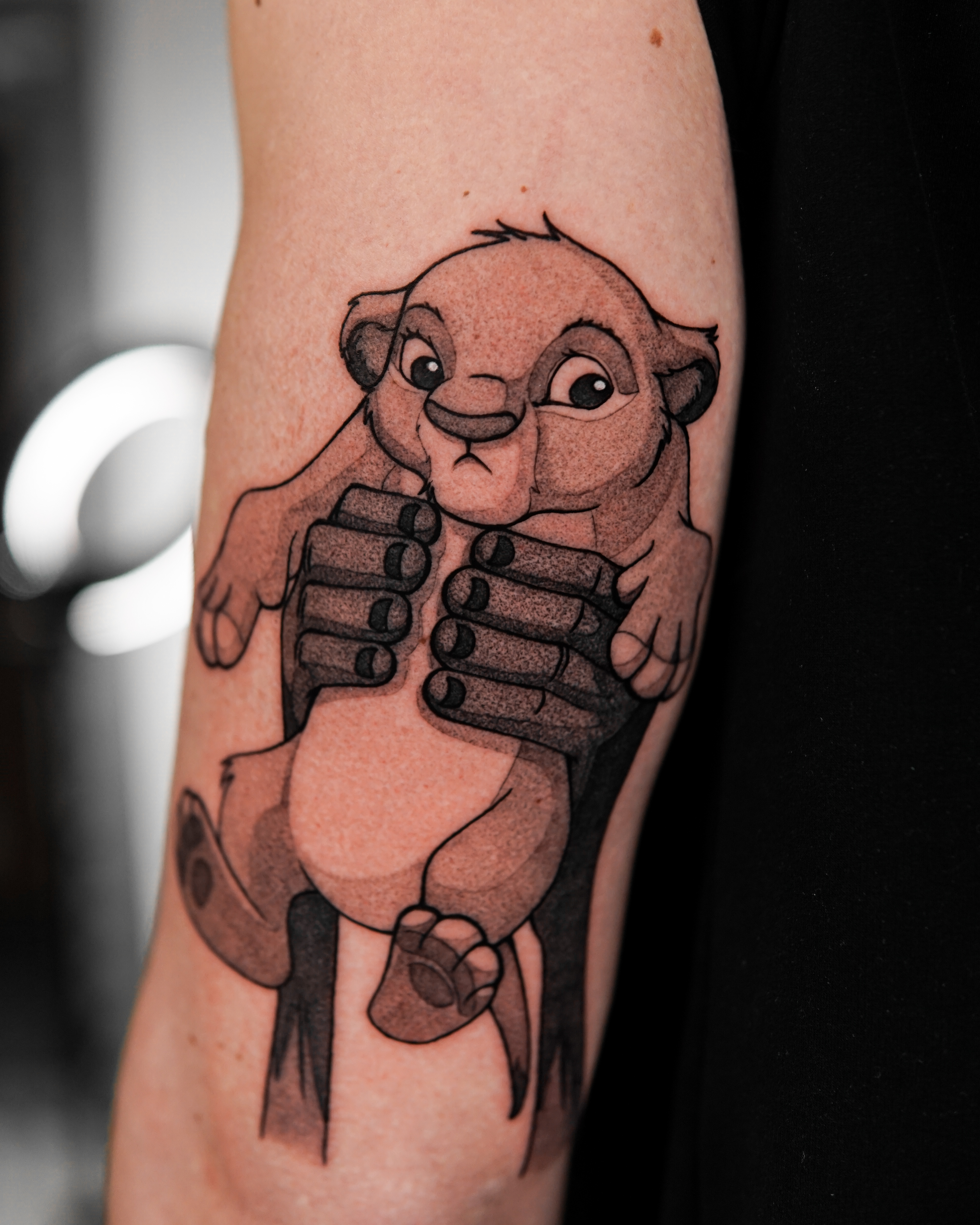 Graphic lion cub tattoo